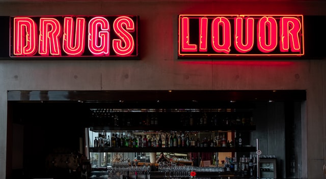 neon sign showing drugs and liquor